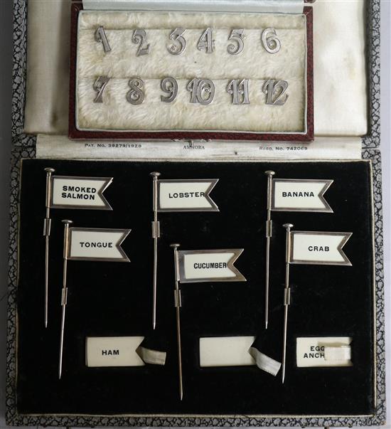 A cased set of six late 1920s silver sandwich flag markers and a set of twelve Dutch white metal Bridge place markers 1-12